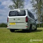 VW T7 in Meadow Green, rear drivers quarter, pop top down