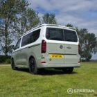 VW T7 in Meadow Green, rear passengers quarter, pop top down