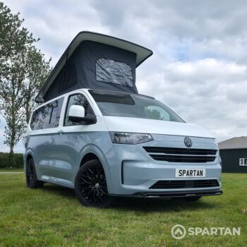 VW T7 SWB Spartan campers campervan in squirrel grey, drivers front quarter with pop top up and wheels turned