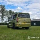 VW T7 SWB Spartan Campers campervan in warm metallic green, passengers rear quarter with pop top roof down