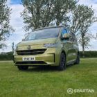 VW T7 SWB Spartan Campers campervan in warm metallic green, passengers front quarter with pop top roof down