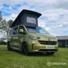 VW T7 SWB Spartan Campers campervan in warm metallic green, drivers front quarter with pop top roof up