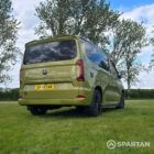 VW T7 SWB Spartan Campers campervan in warm metallic green, drivers rear quarter with pop top roof down