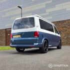 Rear driver's side three-quarter view showing the tailgate, alloy wheels and colour-coded rear styling.