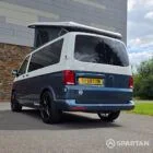 Rear passenger side three-quarter angle of the Spartan VW T6.1 SWB campervan with privacy glass and elevating roof.