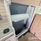 Full-length wardrobe finished in Mocca and Driftwood cabinetry with integrated storage inside the VW SWB camper.