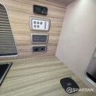 Central control panel mounted within the camper interior for managing electrical systems and lighting.