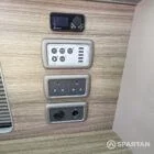 Central control panel mounted within the camper interior for managing electrical systems and lighting.