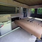 Bright and modern VW SWB Spartan campervan conversion with Winter flooring, Mocca and Driftwood cabinetry, Liquor upholstery, diesel night heater, central control panel and independent LED lighting.